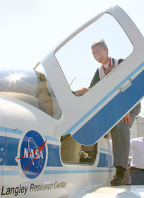 Vic Lebacqz inspects a NASA Cirrus aircraft.